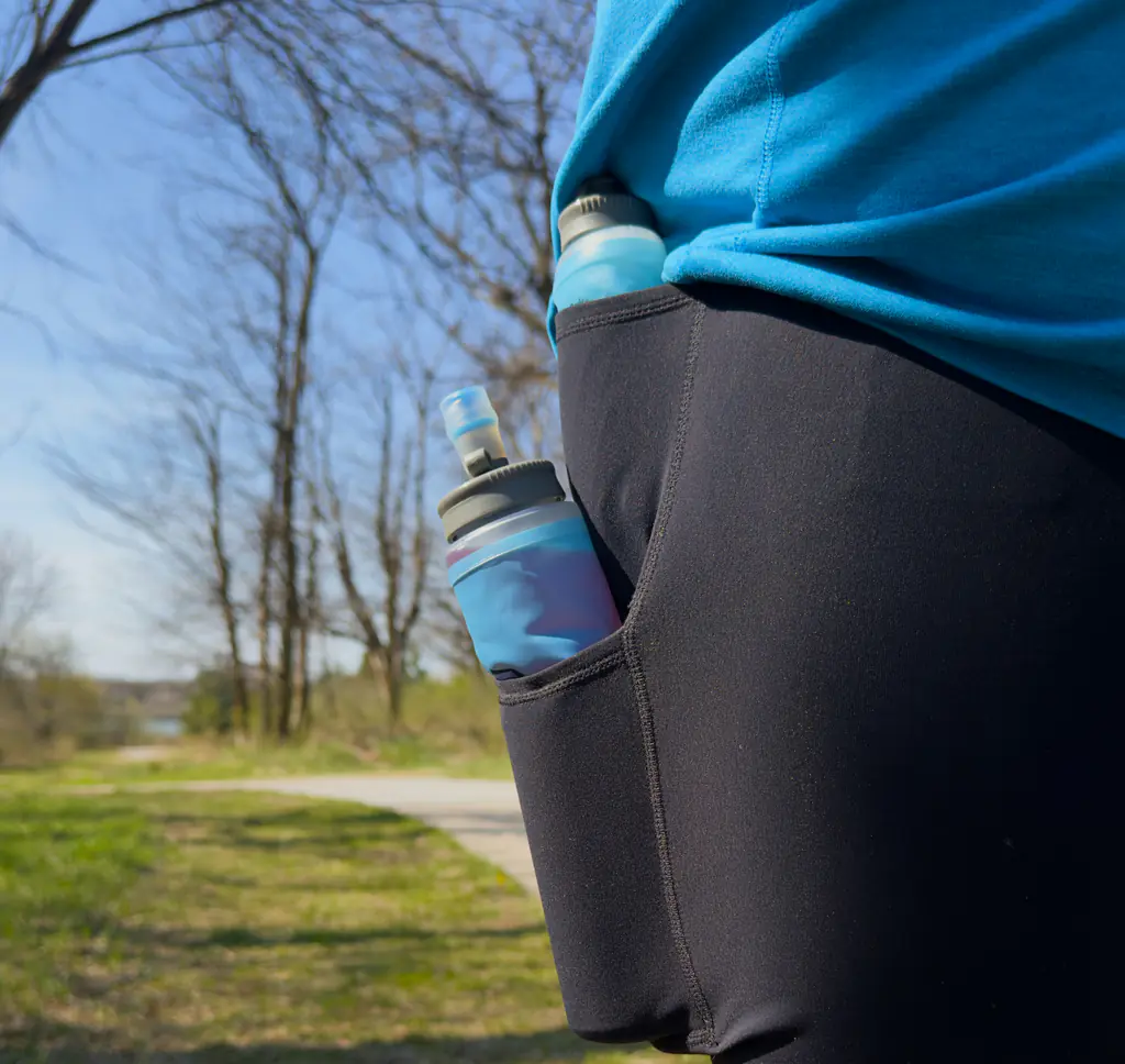 A shot of a 500ml hydration soft flask in the bottom side pocket and a 150ml nutrition soft flask in the top side pocket. Each fits, with a little bit hanging out of the top.