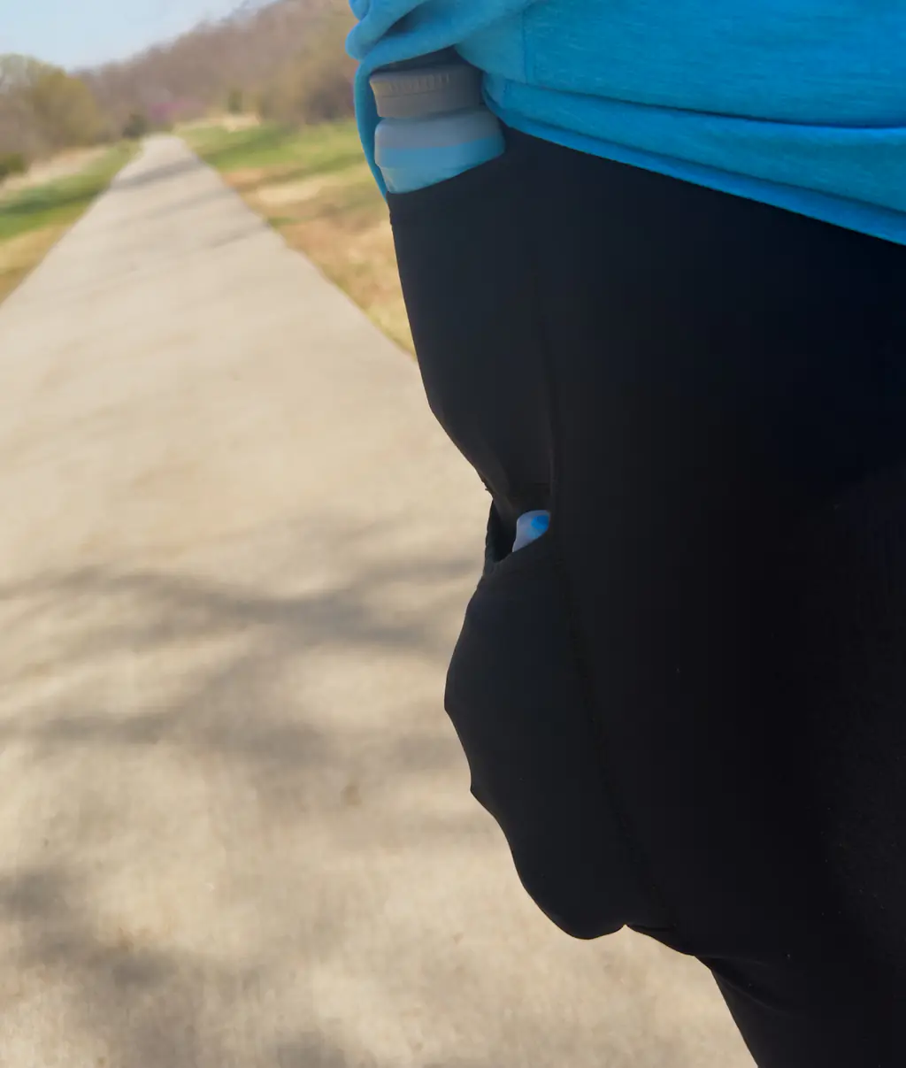 A shot of a 500ml hydration soft flask (three quarters full) in the bottom side pocket, showing how it now compresses down to fit fully.