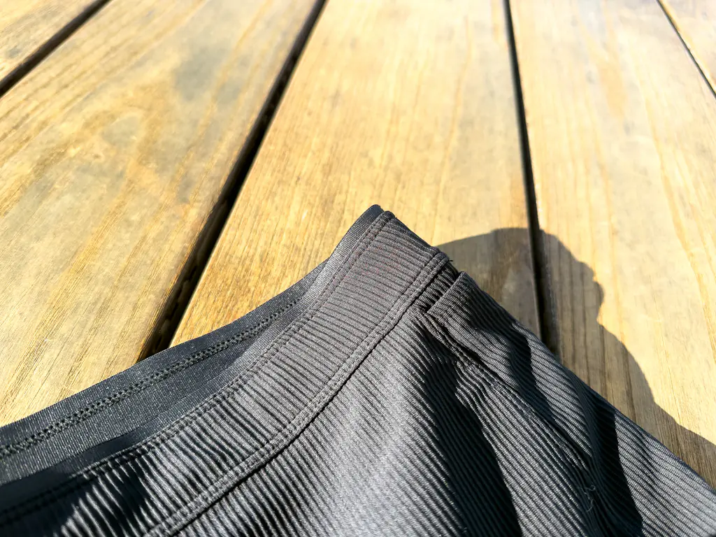 A closeup of the exterior of the waistband, showing the slightly stiffer fabric with a sharper edge, layered behind the face fabric.
