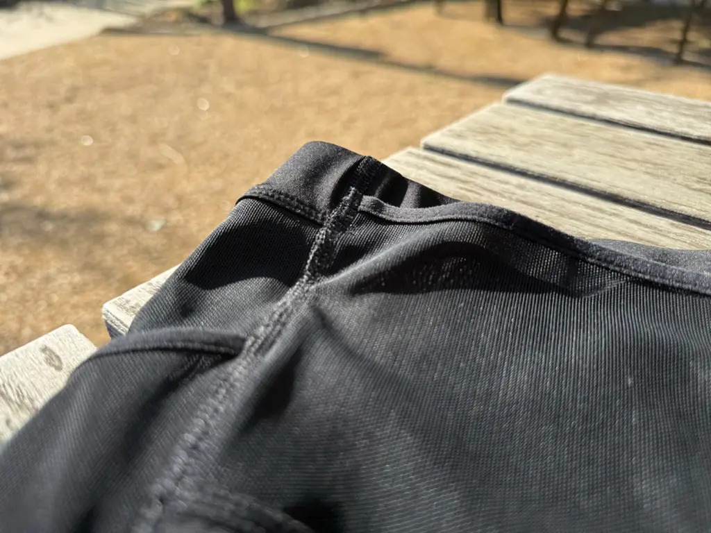 A close up view of the front side seam construction, showing multiple pieces of fabric coming together in one tidy seam