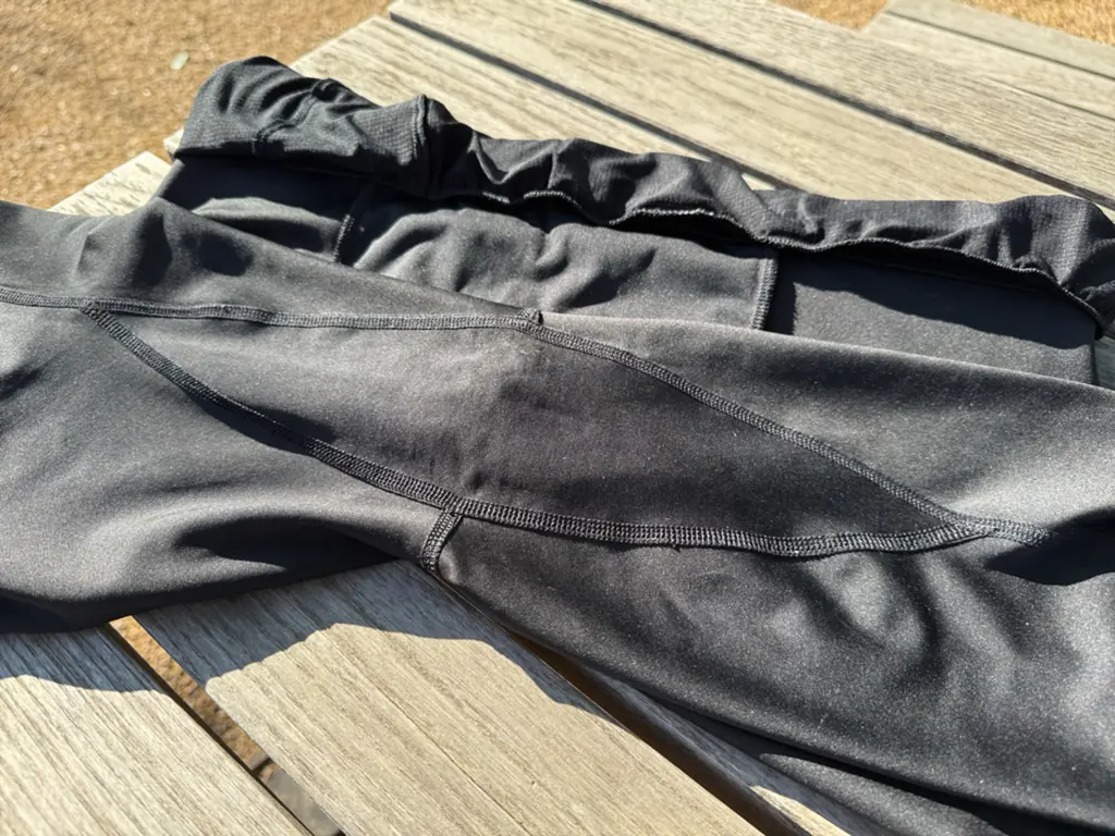A shot of the entire rounded-diamond-shaped crotch gusset, stretching from halfway down one leg to halfway down the other