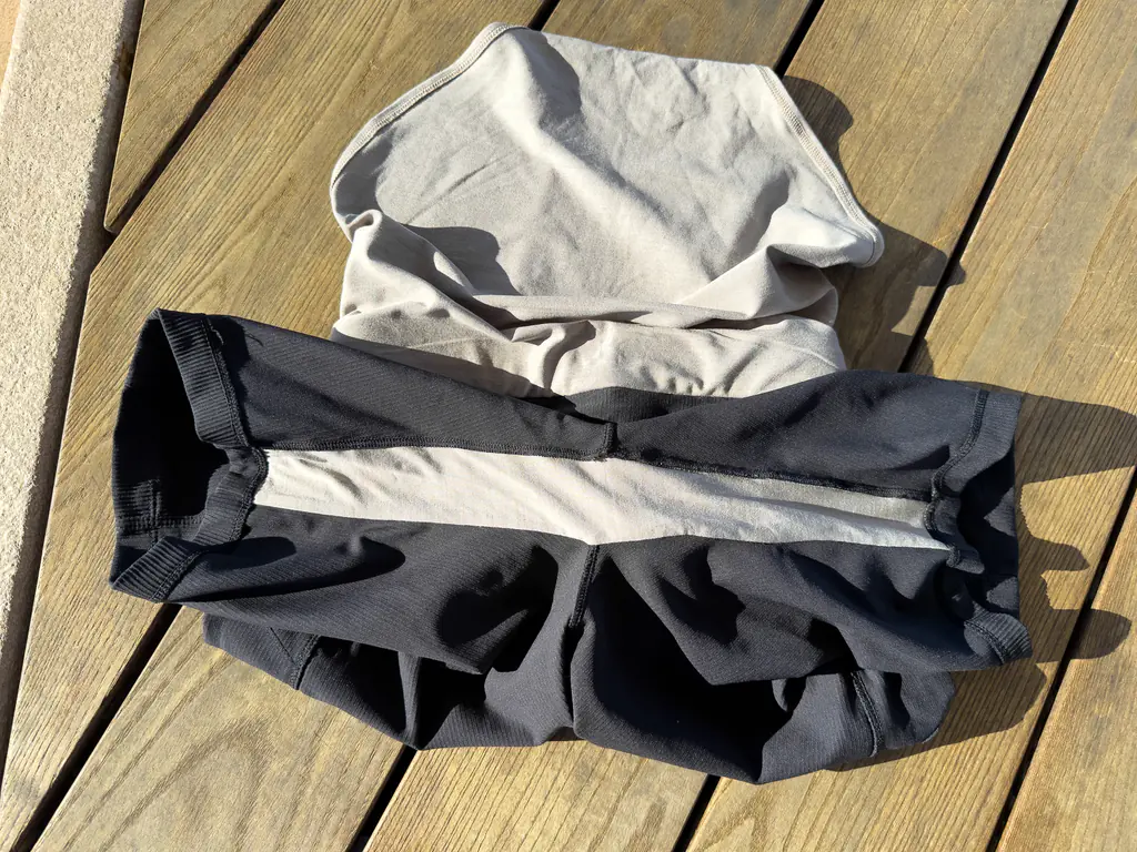 A view of the interior double layer fabric gusset or inseam running from the opening of one leg to the other, using the same fabric inside as the brief liner.