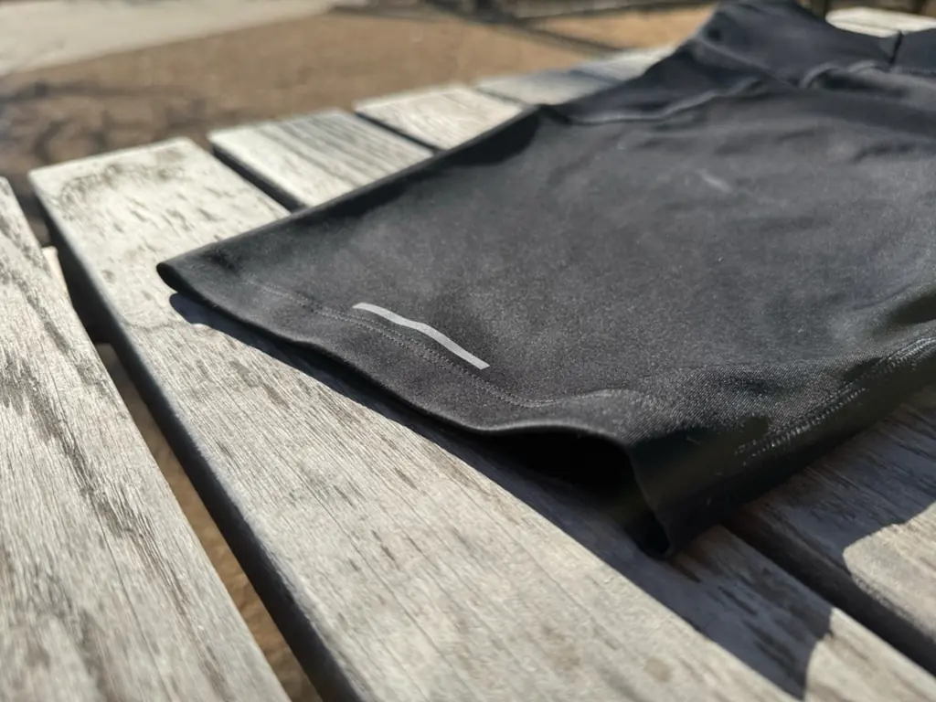 A close up shot of the outside of the leg opening, showing tidy seams and a small reflective detail