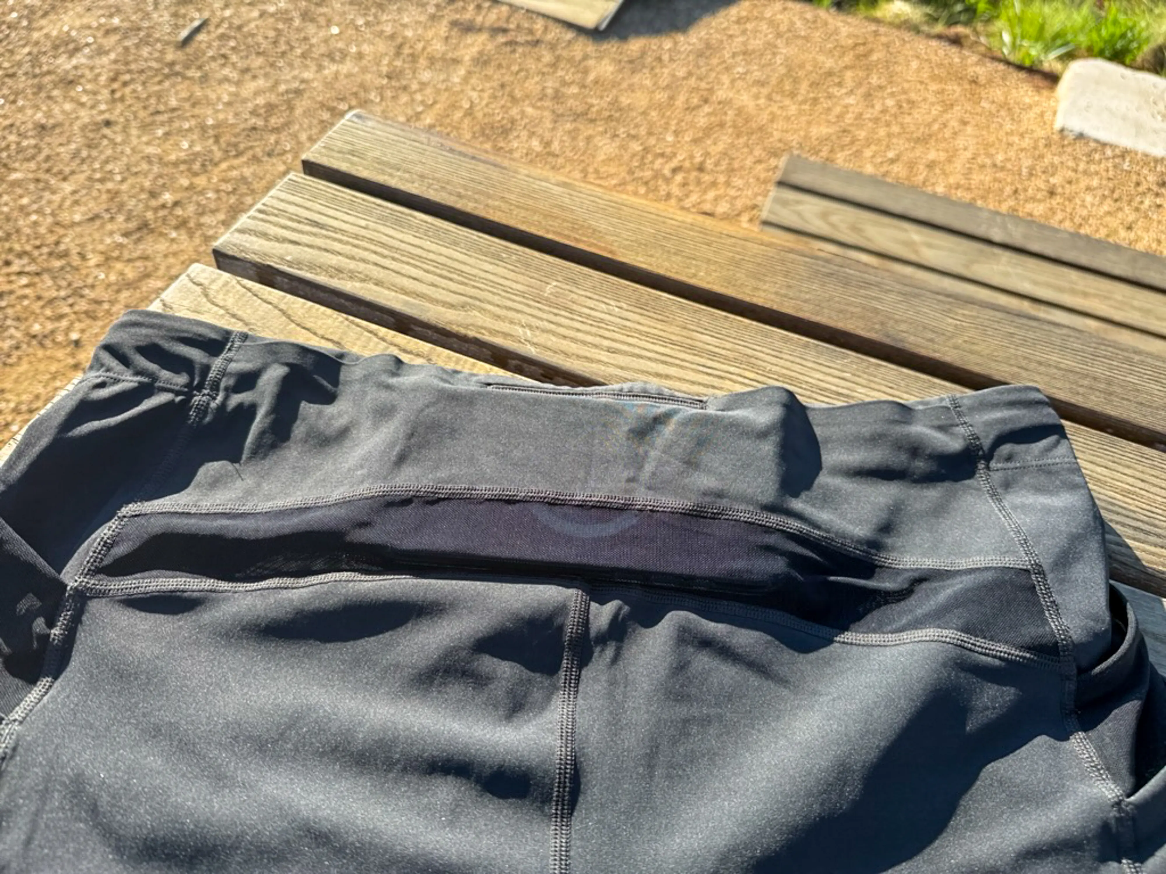 A view of the rear pocket system, with an iPhone Pro Max case nestled in the middle, in the section with a closed off top seam.