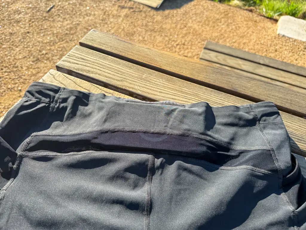 A view of the rear pocket system, with an iPhone Pro Max case nestled in the middle, in the section with a closed off top seam.