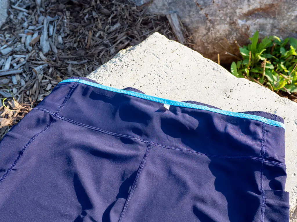 A closeup of the large stretch-mesh storage area running the width of the rear waistband