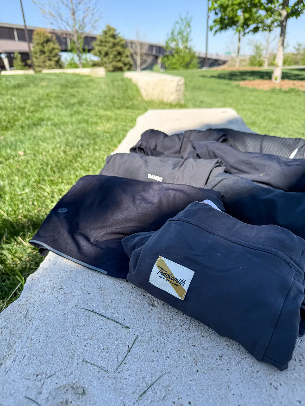 A variety of half tights, rolled up and sitting on a rock bench