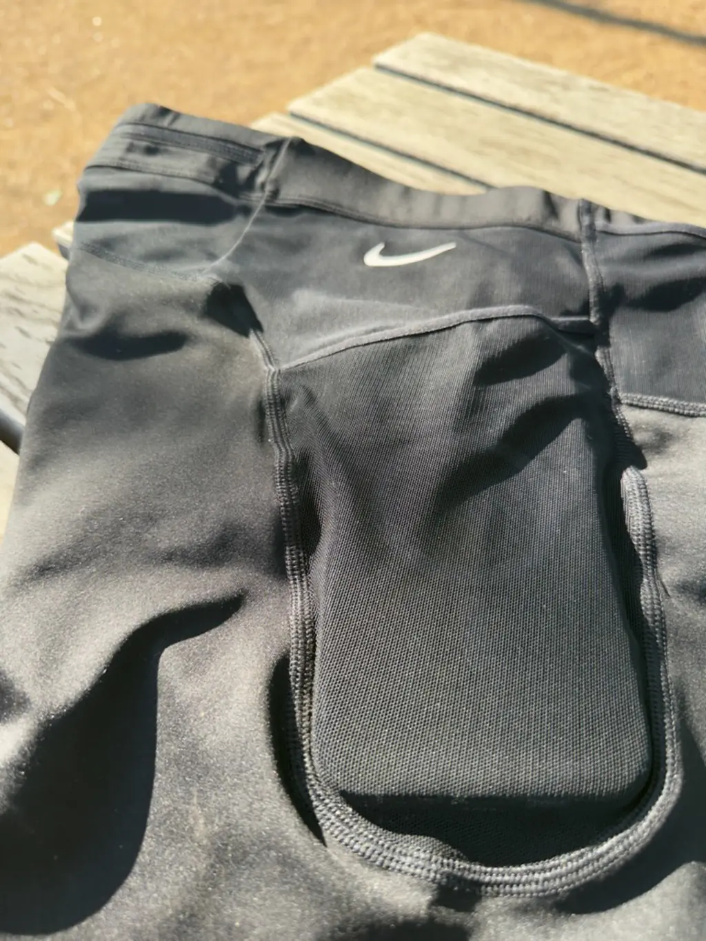 A close up view of the side pocket with an iPhone 12 Pro Max case in it, showing the case easily fits with plenty of room to spare