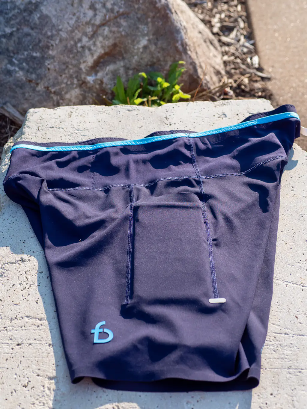 A top down view of the thigh pocket, holding an iPhone 12 Pro Max with room to spare