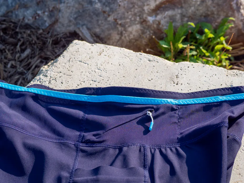 A closeup of the zippered storage pocket on the front right of the waistband